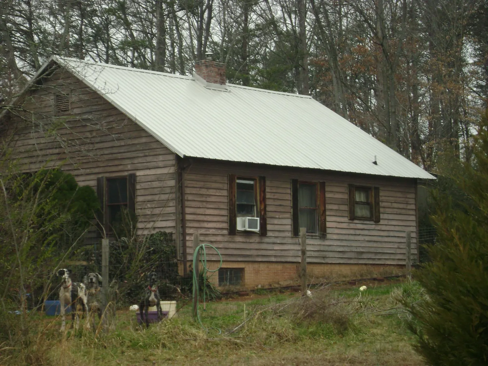 White metal roof on an old wood sided farmhouse, from a Metal Roof Installation job in Chadbourn